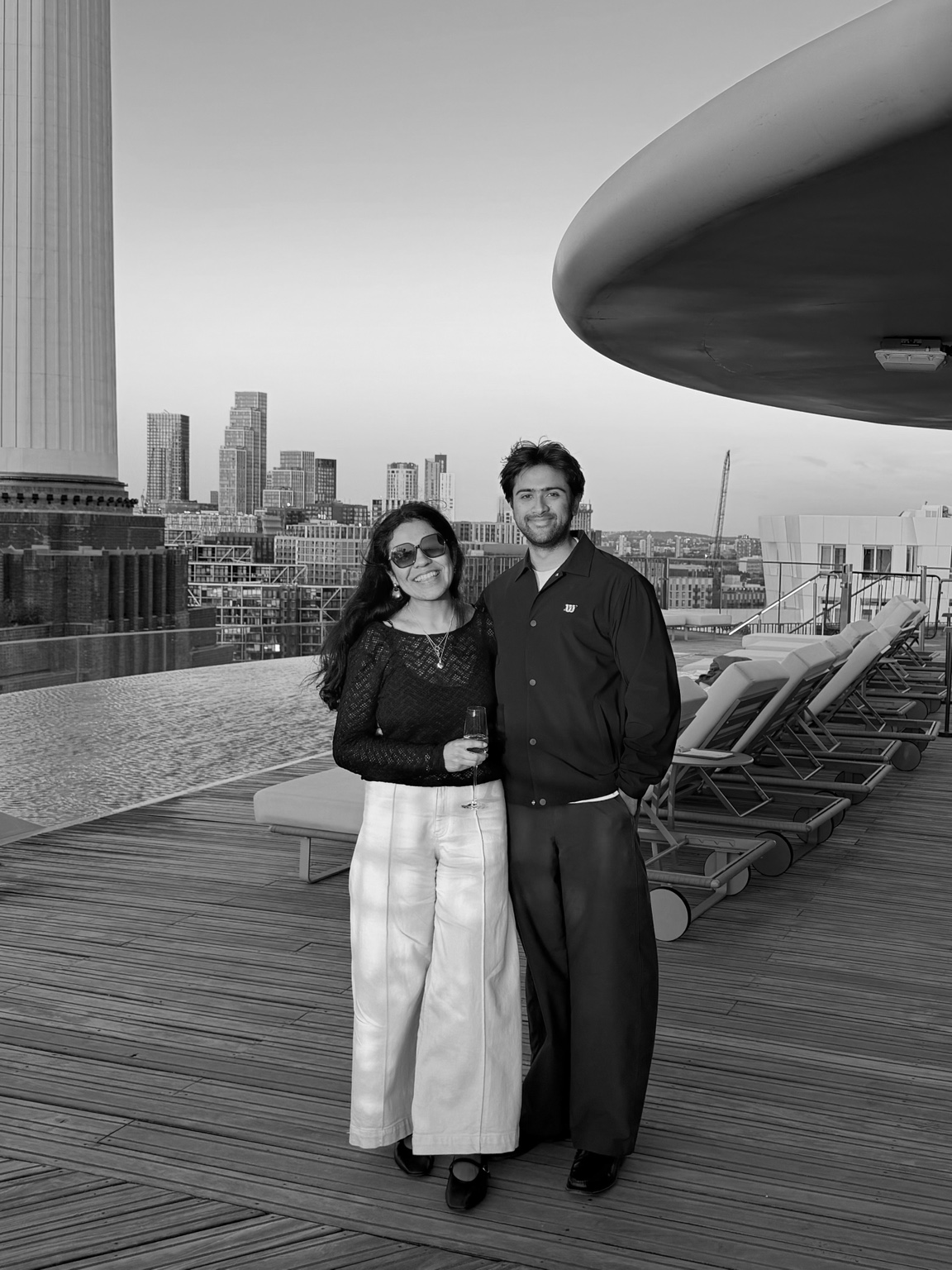 Black-and-white portrait of Pamela and Hussain together on a rooftop terrace