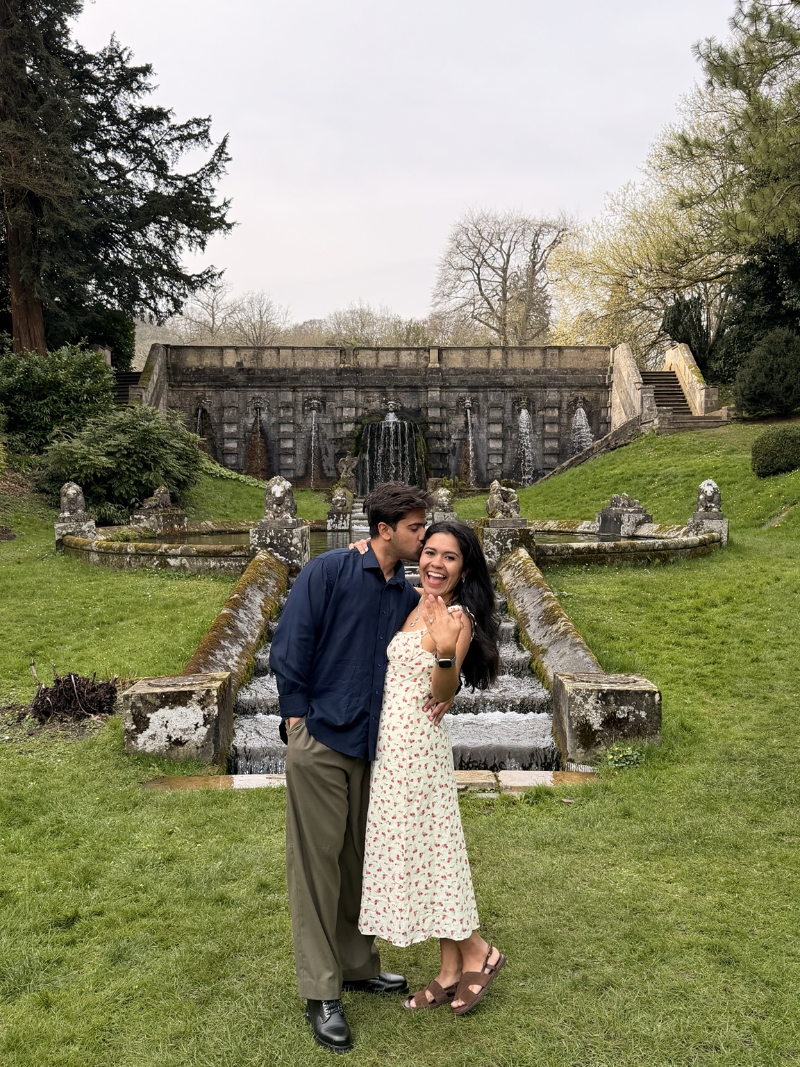 Pamela and Hussain celebrating their engagement in a garden